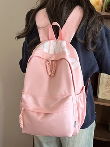 Pink waterproof nylon backpack with white letter print for casual school and commute
