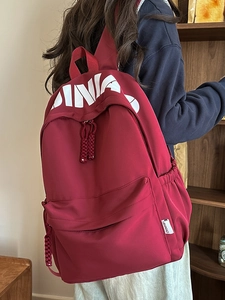 Minimalist burgundy canvas backpack with white INIA letter print for stylish students