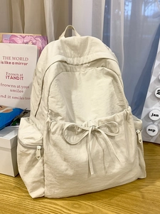 Minimalist beige ballet style nylon backpack with bow drawstring and large capacity