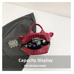 Top view of red PU leather rivet handbag showing interior space with cosmetics