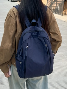 Minimalist navy blue waterproof nylon backpack for women with multiple zipper pockets