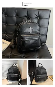 Detailed view of punk style black backpack with silver cross and stud decorations