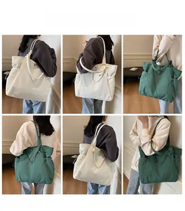 Detailed model views of large canvas tote bags in off-white and dark green colors