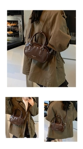 Détail du sac polochon en cuir verni brillant marron foncé avec bandoulière réglable