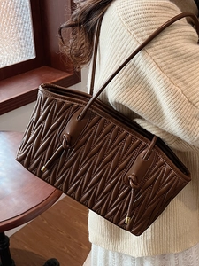 Chic dark brown pleated leather bucket bag for women with elegant matelasse texture