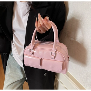 Detail view of the pink oil wax leather Boston handbag with dual front pockets and silver hardware