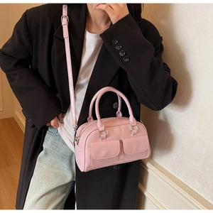Pink boston style handbag in oil wax leather with front pockets and silver hardware detail