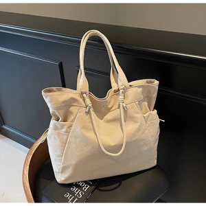Close-up of beige canvas tote bag showing durable texture and drawstring details