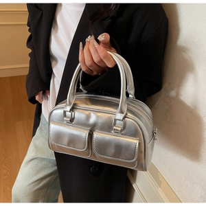 Detail of silver oil-wax leather Boston bag with double front pockets and metallic finish