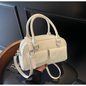 Detail view of white glossy oil wax leather Boston bag with silver hardware pockets