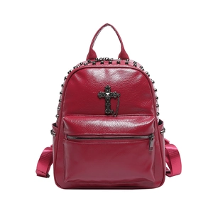 Dark red faux leather backpack with metallic rivets and a vintage cross chain detail