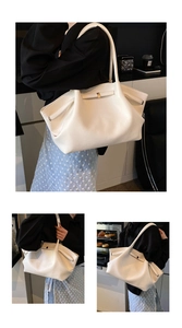 Detail of white textured leather tote bag featuring gold square buckle and side pleats