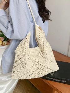 Handmade cream crochet tote bag with geometric hollow weave pattern for beach vacations
