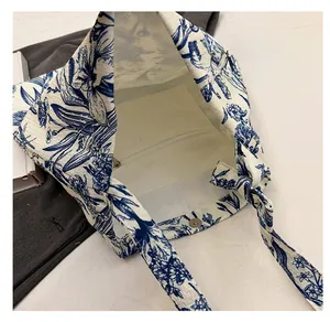 Detail view of canvas tote interior with Toile de Jouy print and inner zipper pocket