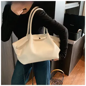 Detail of white lychee grain leather tote bag with elegant golden square buckle accent