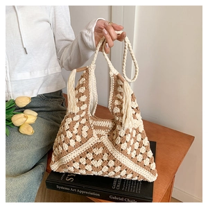 Close-up of bohemian woven tote bag with geometric patterns and tassel details