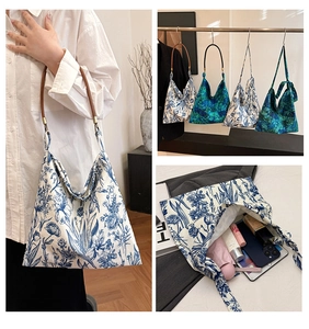 Detail view of floral canvas tote bags with leather straps and spacious inner capacity
