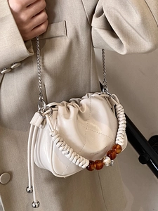 Chic cream white drawstring bucket bag with amber bead handle and silver chain strap