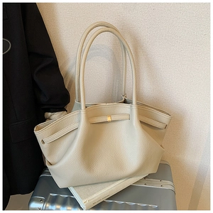 Close-up of cream pleated tote bag featuring lychee texture leather and gold buckle