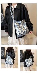Detail of floral canvas tote bag featuring blue botanical prints and wide shoulder strap