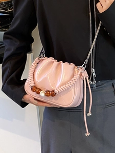 Pink glossy ruched bucket bag with woven handle and pearl bead accents in 2025 spring style