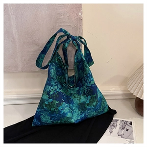 Detailed view of casual cotton tote bag featuring retro blue and green floral embroidery