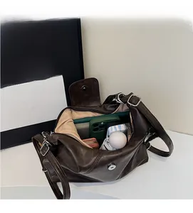 Detailed interior of vintage dark brown tote showing capacity for phone and umbrella