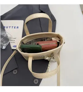 Spacious interior of yellow PU leather bucket bag holding a phone and wallet