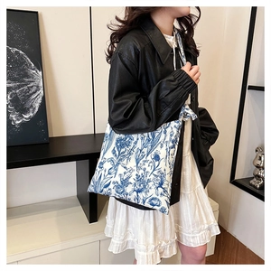 Detail of canvas tote bag featuring vintage blue and white floral prints for women