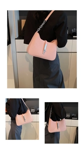 Detail of pink hobo bag with woven texture and silver piston lock closure