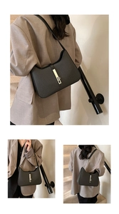Detail of black woven texture underarm bag with silver metal buckle and chain strap