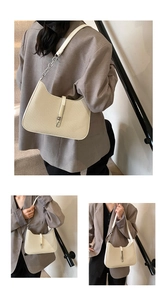 Close-up of woven texture and silver piston buckle on beige minimalist shoulder bag
