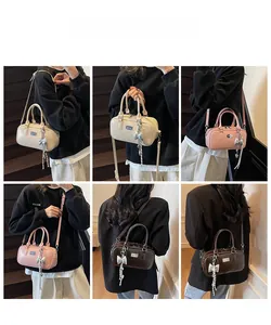 Detail showing versatile bowling bag styling in cream, pink, and dark brown colors