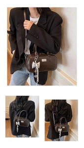 Deep coffee vintage Boston bag featuring a silver bow charm and adjustable crossbody strap
