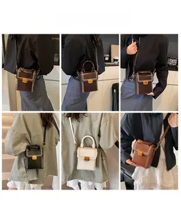 Detailed view of mini retro box bag with contrast stitching and metal twist lock closure