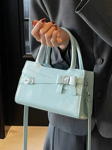 Minimalist mint green patent leather handbag with bow detail for women in 2025 style
