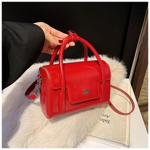 Detail of red oil wax leather square handbag with flap closure and adjustable strap