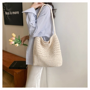 Dettaglio borsa tote beige all'uncinetto con trama intrecciata e morbido materiale in cotone