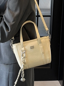 Minimalist beige leather bucket bag with metal logo and woven pendant for women