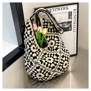 Detail of crochet tote bag showing handmade hexagonal patterns and soft cotton texture