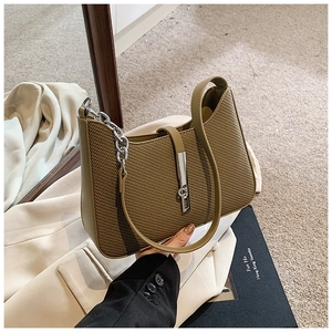 Detail of olive green woven shoulder bag with silver chain strap and metal buckle closure