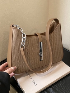 Chic woven underarm bag with leather trim and silver chain detail in deep beige