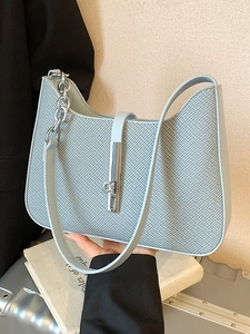 Minimalist light blue woven underarm bag with silver bar lock and chain strap