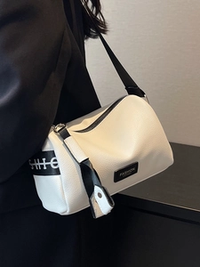 White lychee leather pillow crossbody bag with wide logo strap and fashion leather patch