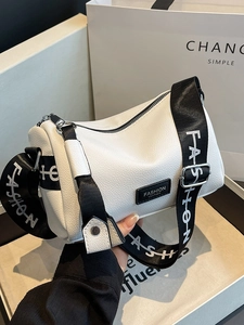 White lychee pattern cross-body pillow bag with a wide adjustable lettered strap