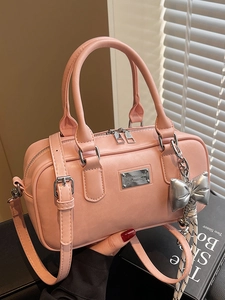Pink minimalist bowling handbag with silver logo plate and bow charm for women