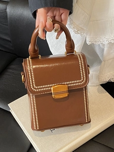 Retro brown leather top handle box bag with elegant gold metal buckle and beaded trim