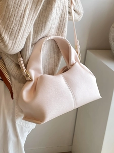 Minimalist light pink cloud crossbody bag with soft pleats and textured faux leather finish