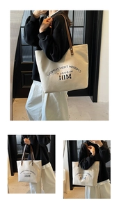 Close-up of minimalist canvas tote with leather straps and Cherish Every Moment print