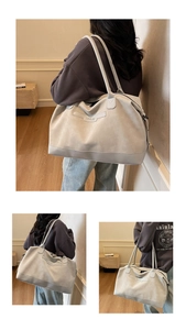 Detail shot of a large light gray suede tote bag with NINGJIA logo and spacious interior